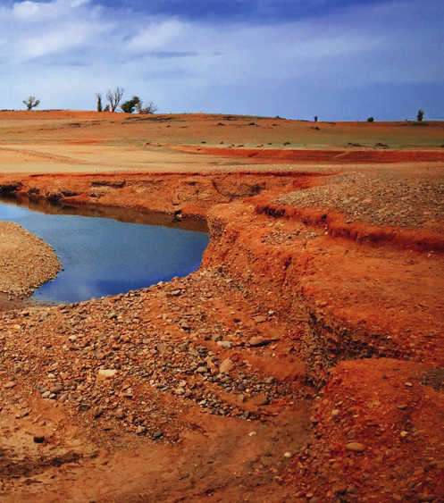 Drought conditions in California — parched earth with a small water channel