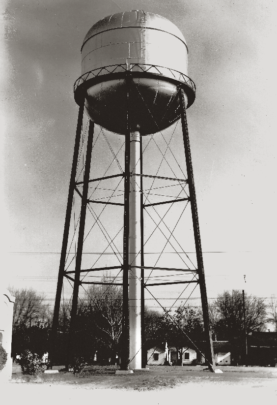 Black and white photograph of an early elevated water storage tank that used gravity to provide water pressure