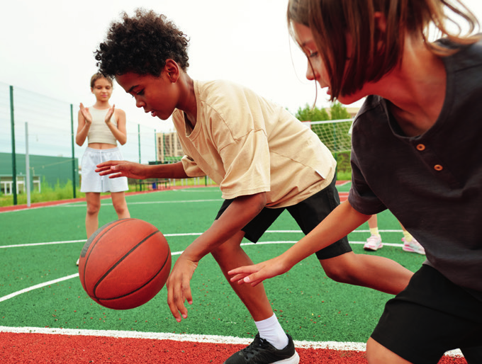 Children playing basketball at a Boys & Girls Club court